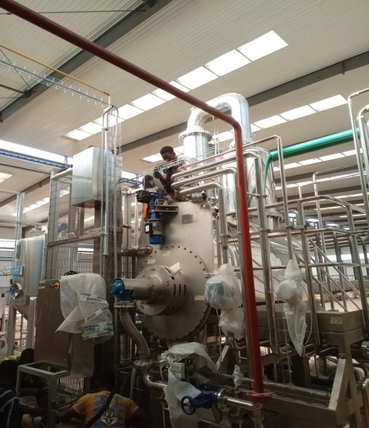 Factory technician performing high-level piping setup