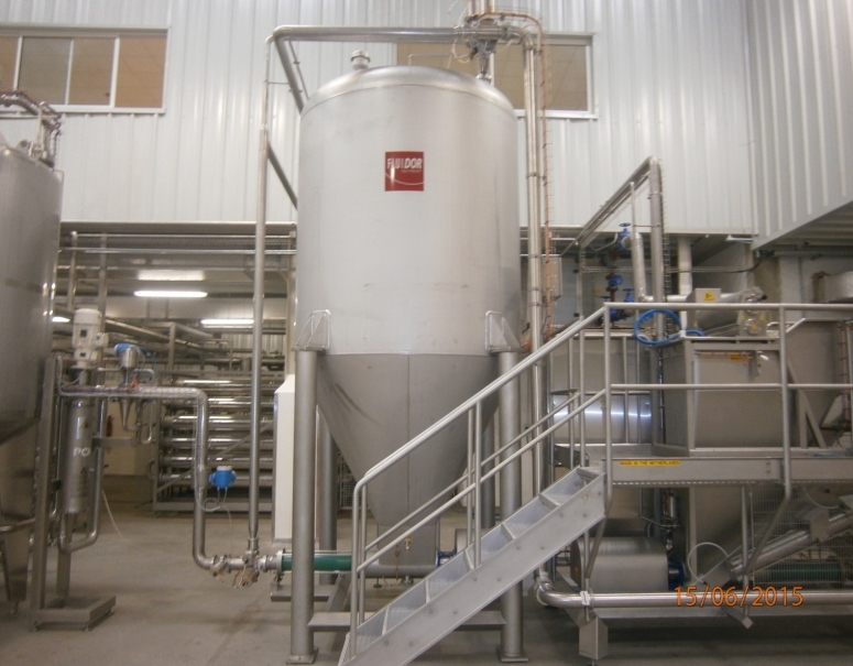 Stainless storage silo setup with inspection staircase