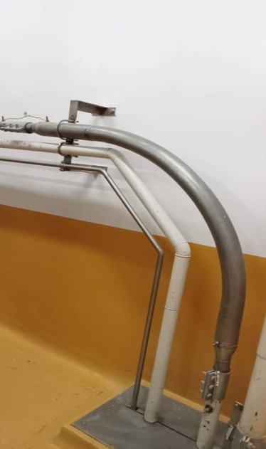 Dual overhead stainless conduit tracks wrapping corner