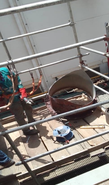 Worker executing high level structural pipe weld fix