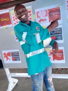 Technician smiling in green and blue branded work vest