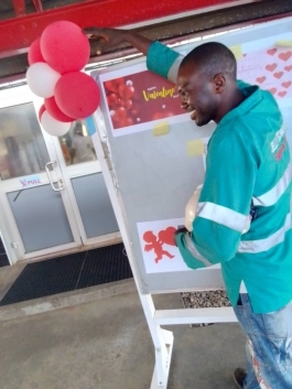 Plant staff member showing facility display backdrop
